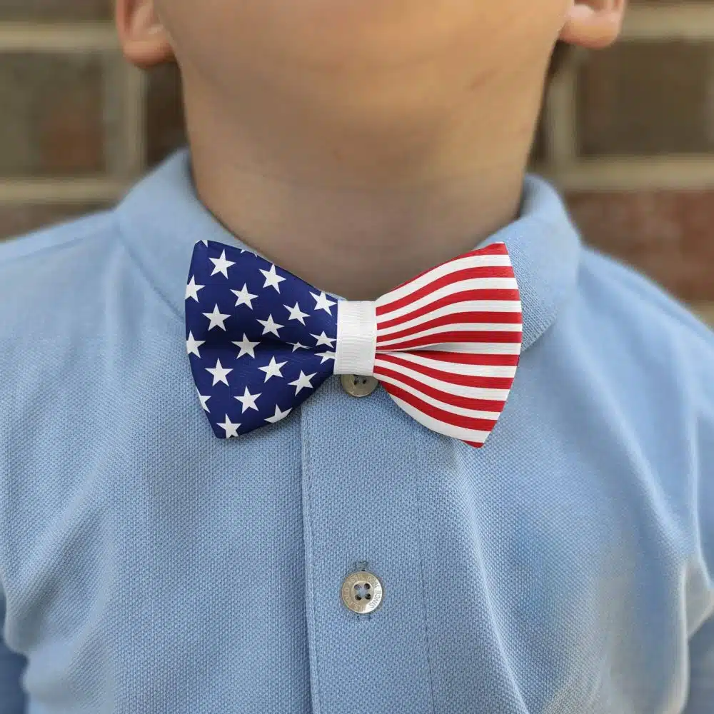 Child wearing patriotic bow tie and blue shirt.