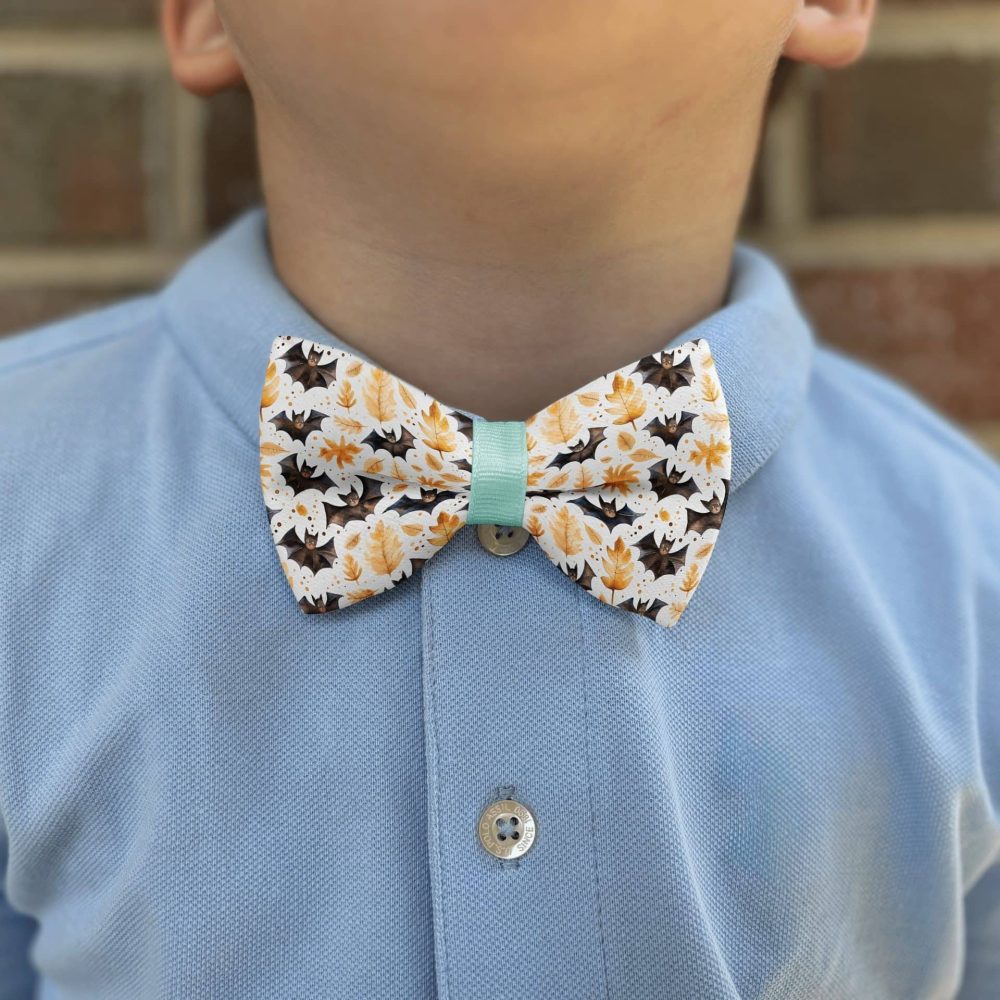Child wearing floral bowtie and blue shirt