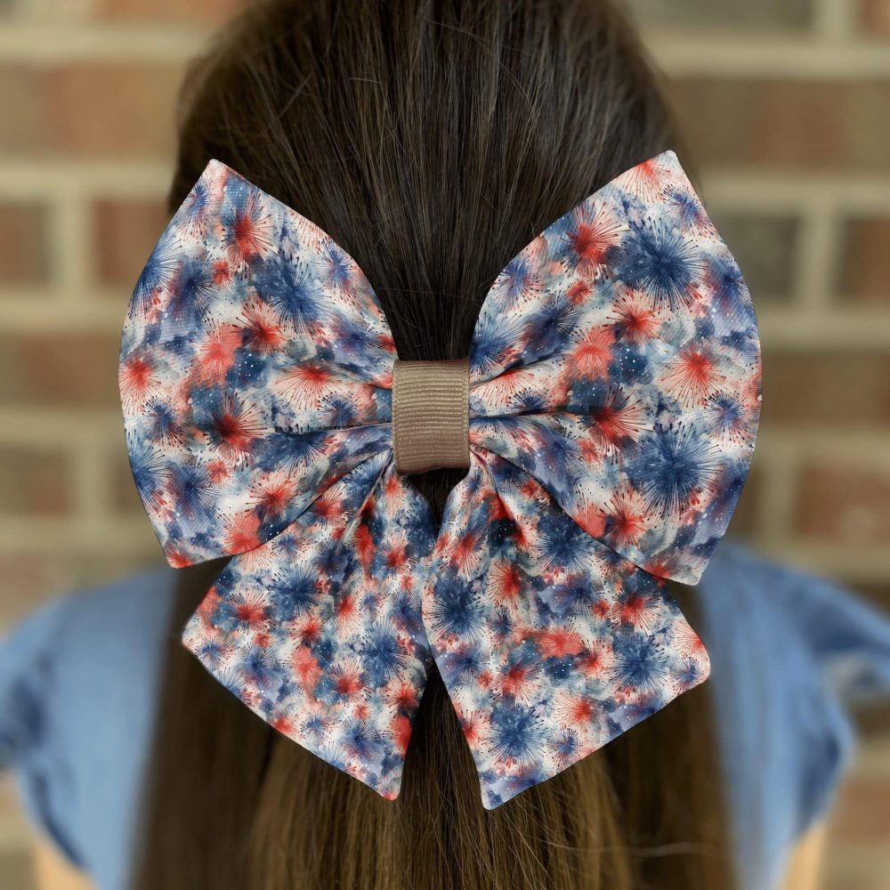 Woman with large red, white, blue bow in hair.