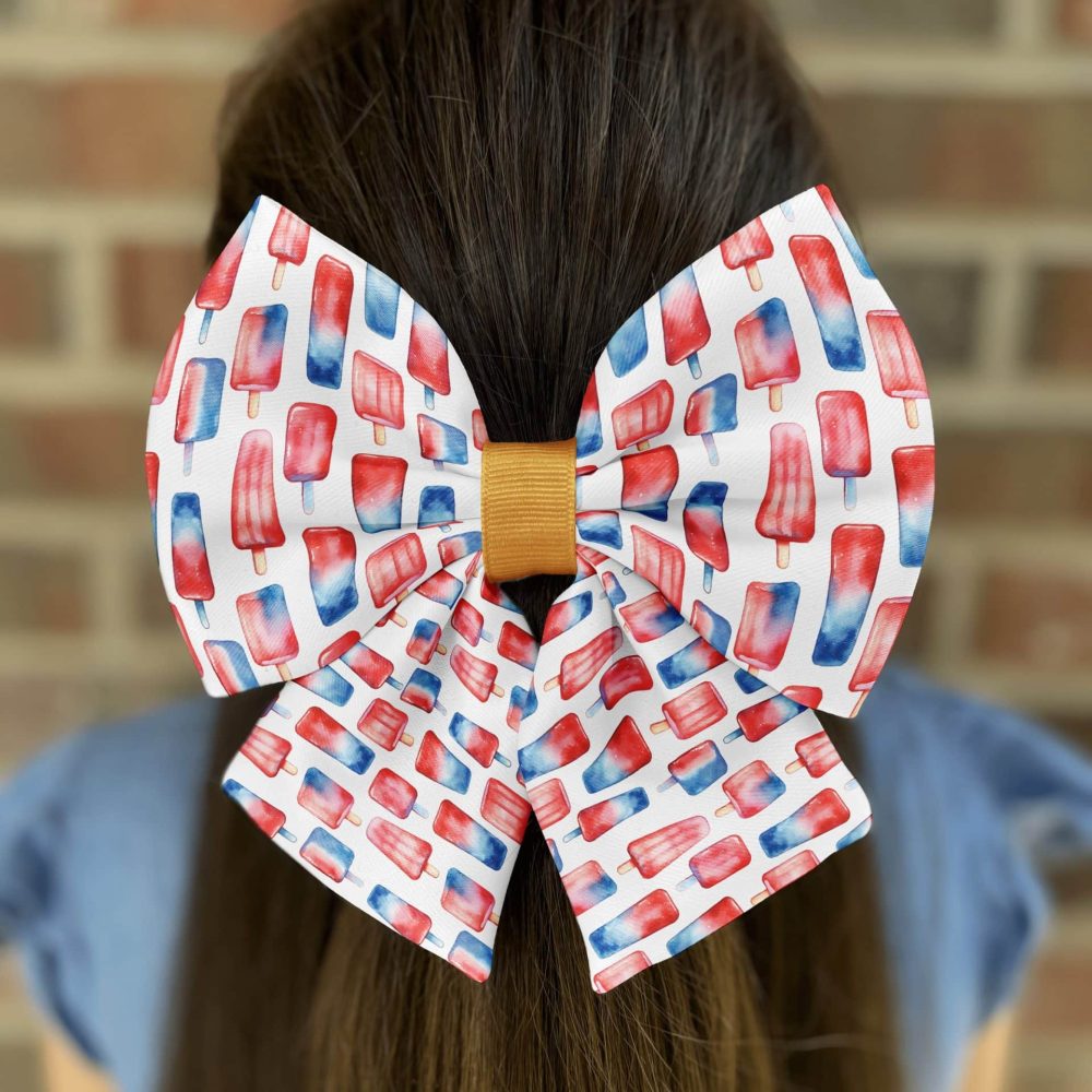Hair bow with red, white, and blue popsicle pattern.