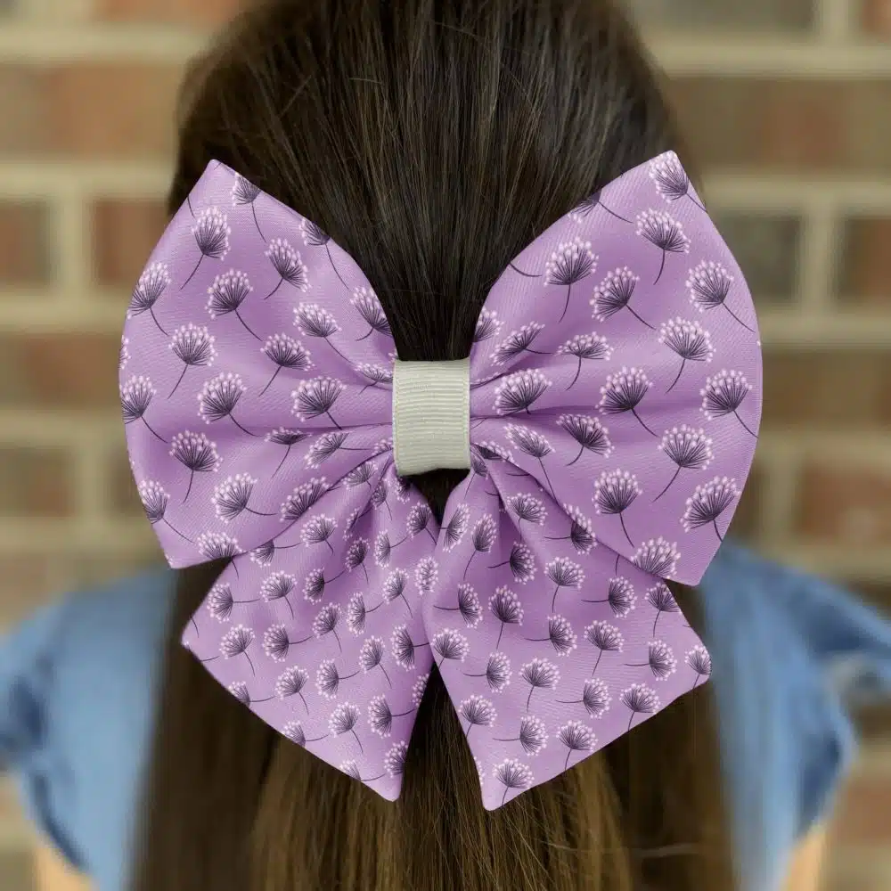 Purple floral bow on brown hair