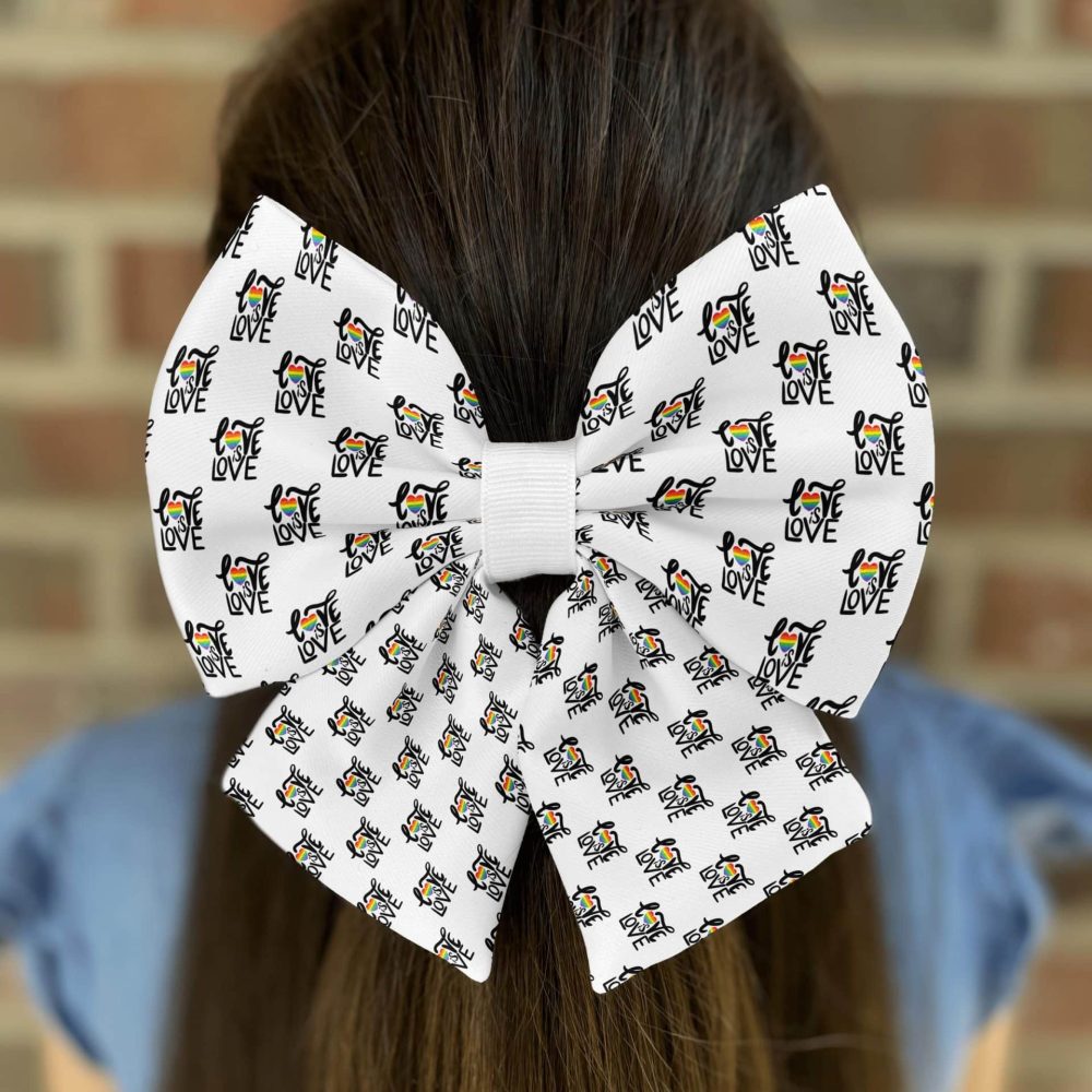Hair bow with 'LOVE' and colorful dog design.