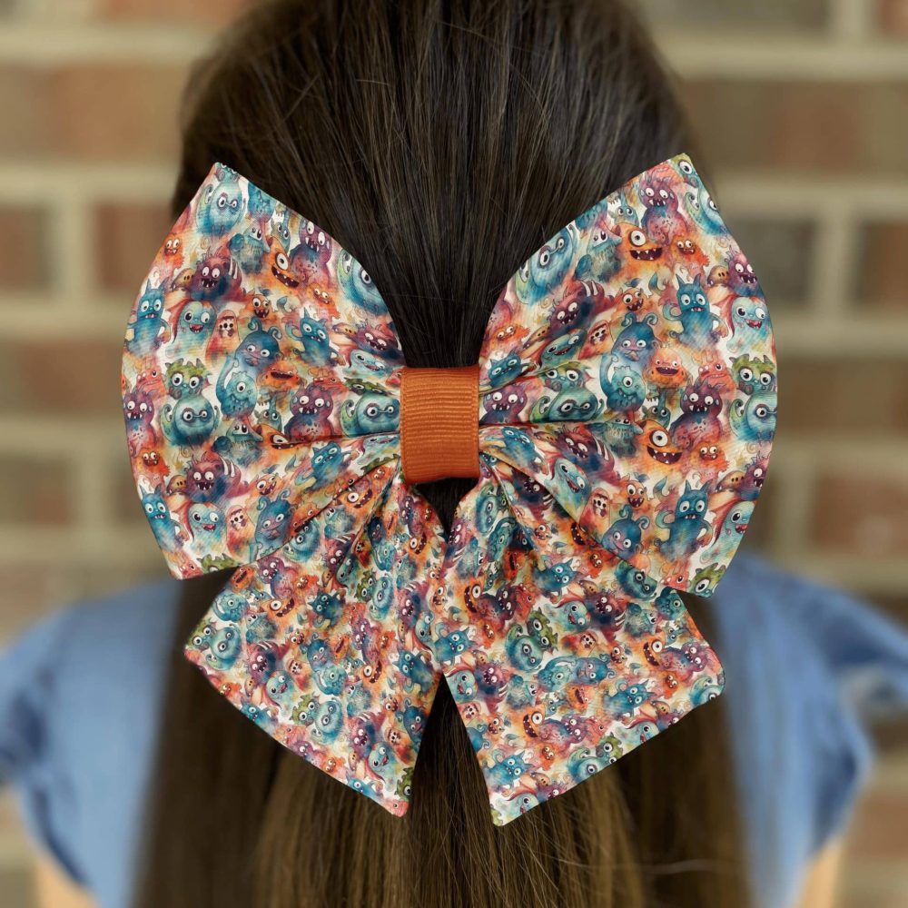 Bright bow with cartoon faces on girl's hair.