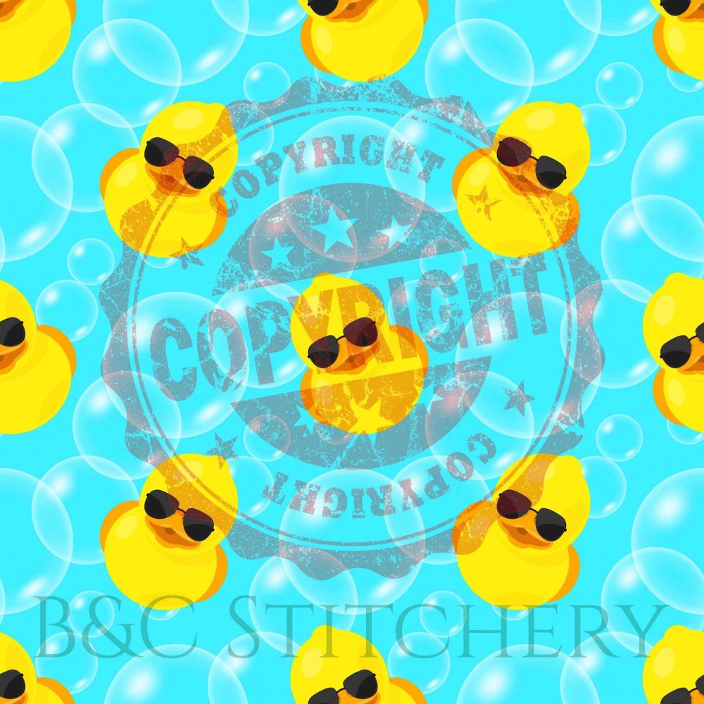 Yellow rubber ducks with sunglasses on blue background.