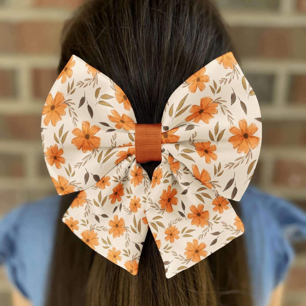 Hair bow with orange flower pattern