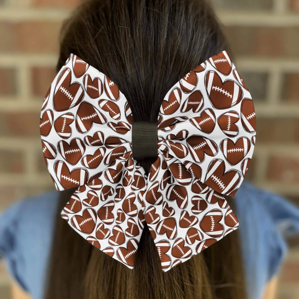 Hair bow with football pattern design.