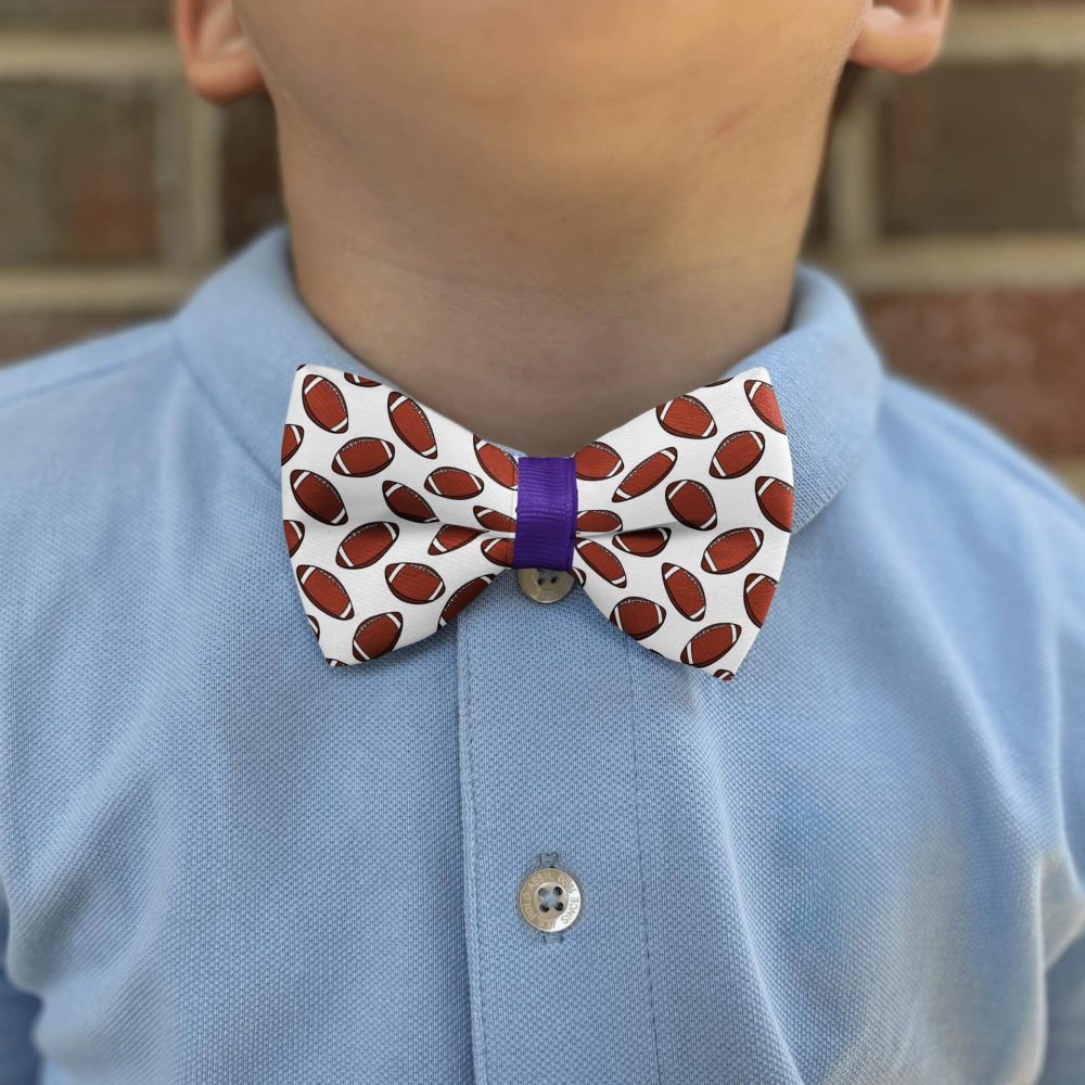 Child wearing bow tie with football design