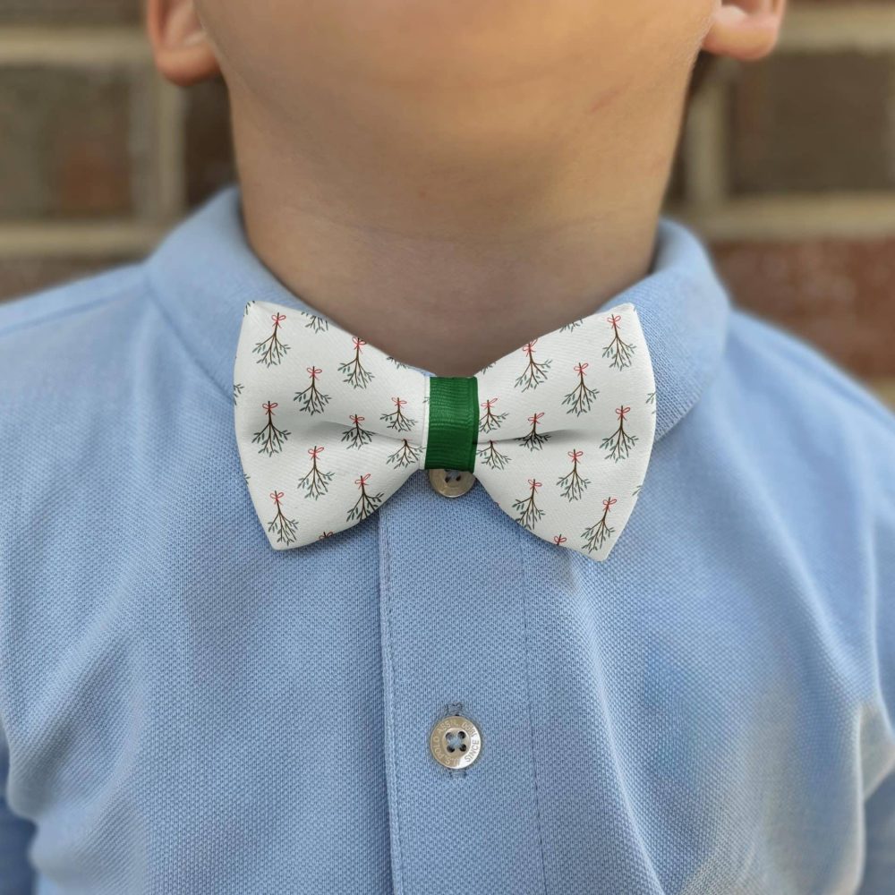 Child wearing festive bow tie and blue shirt.