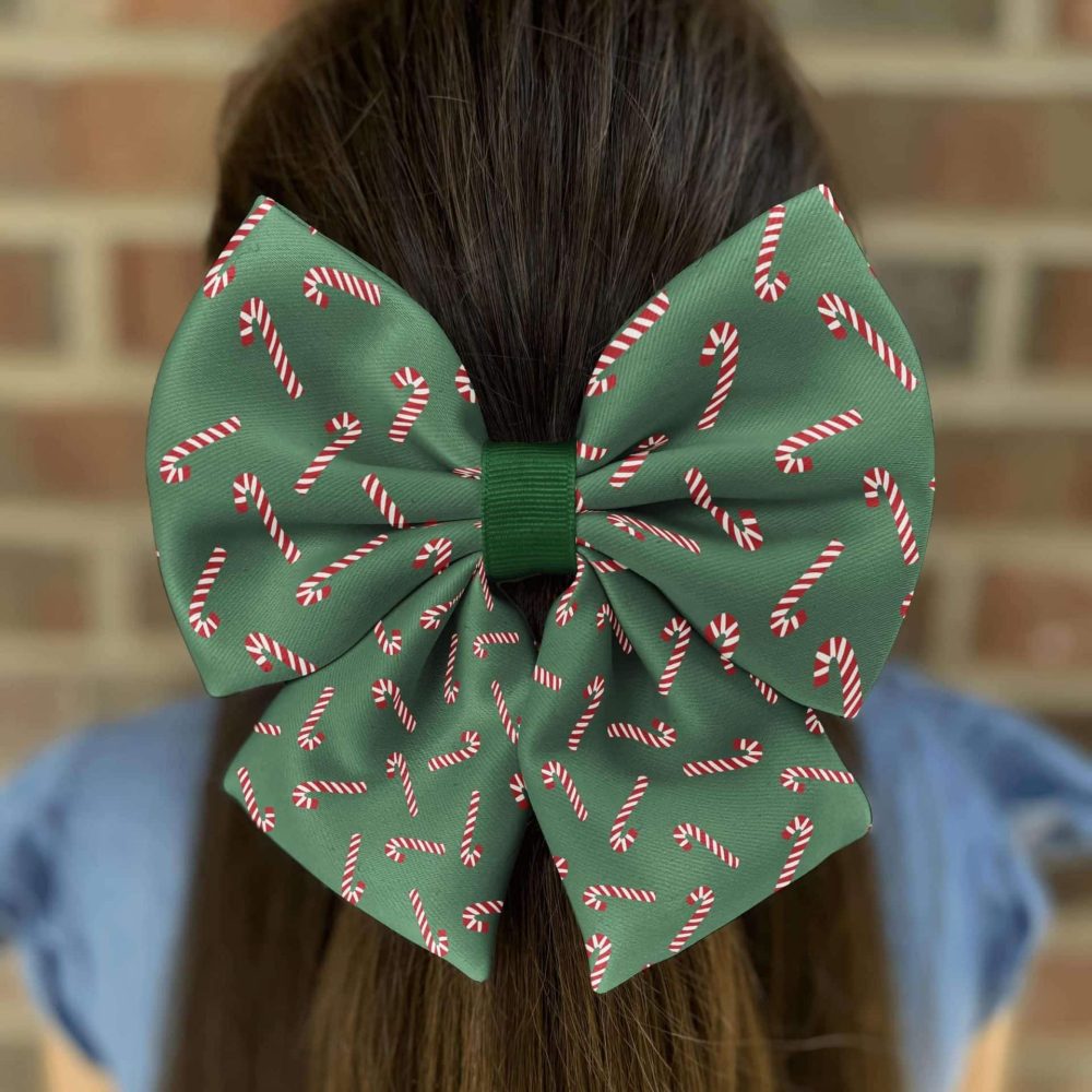 Green bow with candy cane pattern on hair