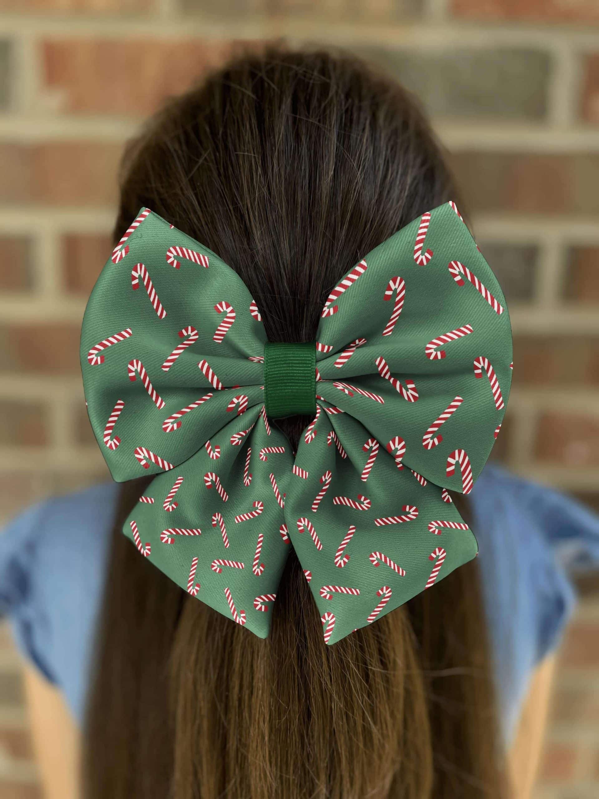 Green bow with candy cane pattern on hair