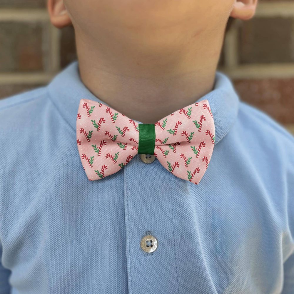 Child wearing candy cane bow tie and blue shirt.