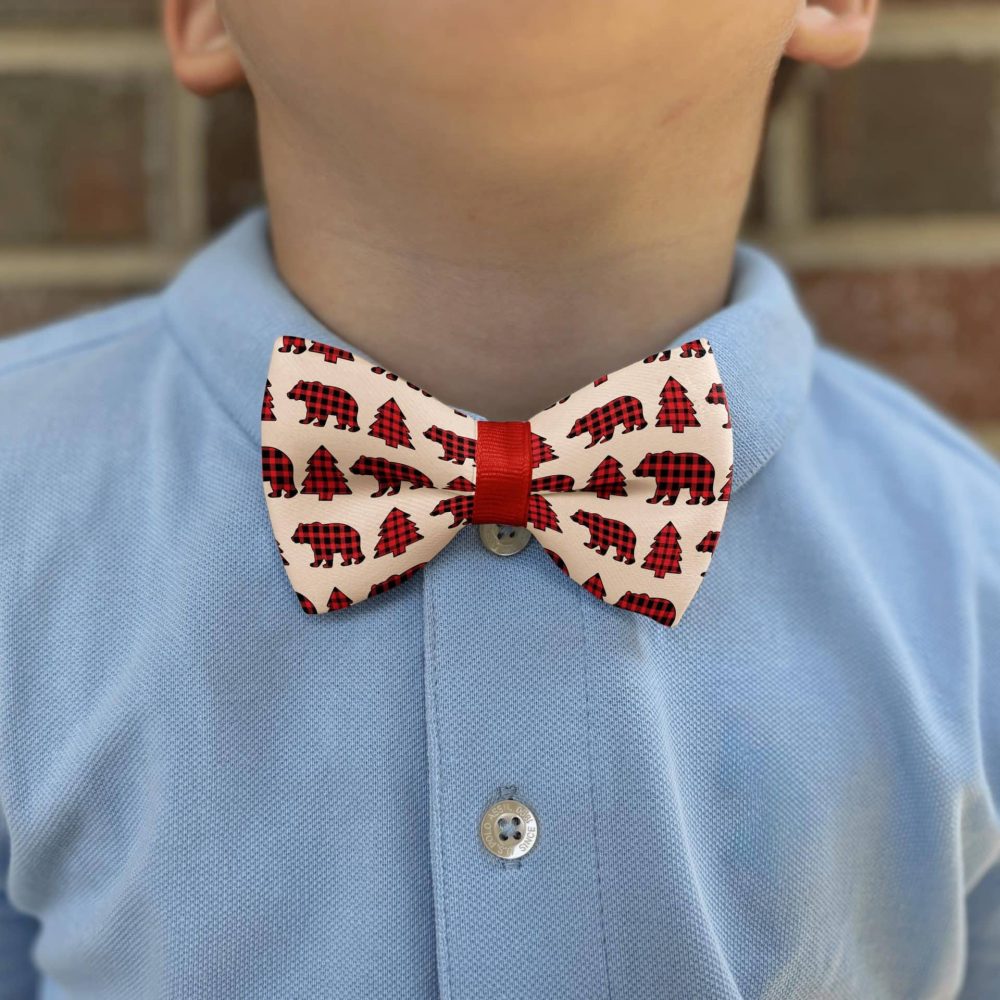 Child in blue shirt wearing bear bow tie