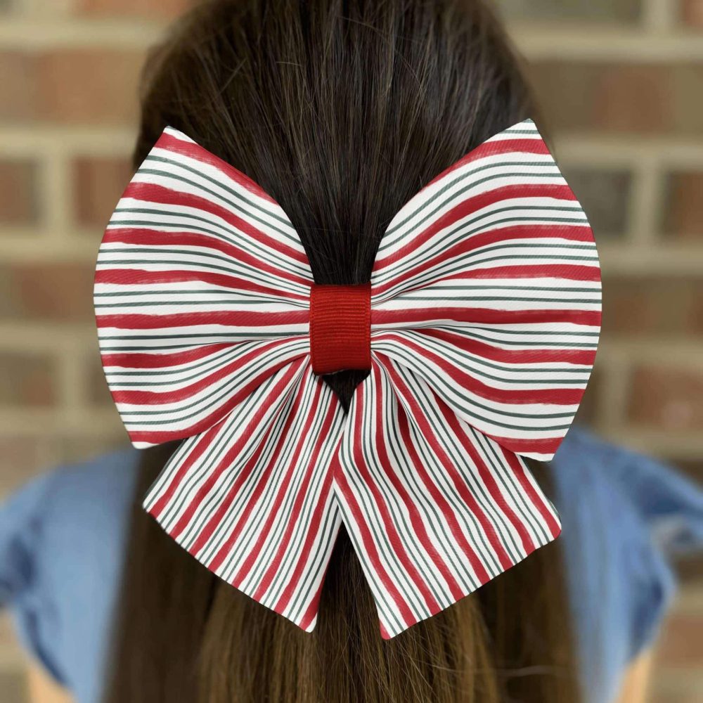 Red striped bow on long brown hair