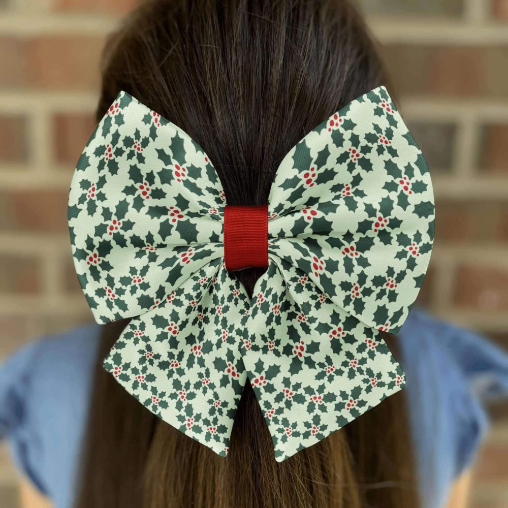 Hair with large holly-patterned bow accessory.