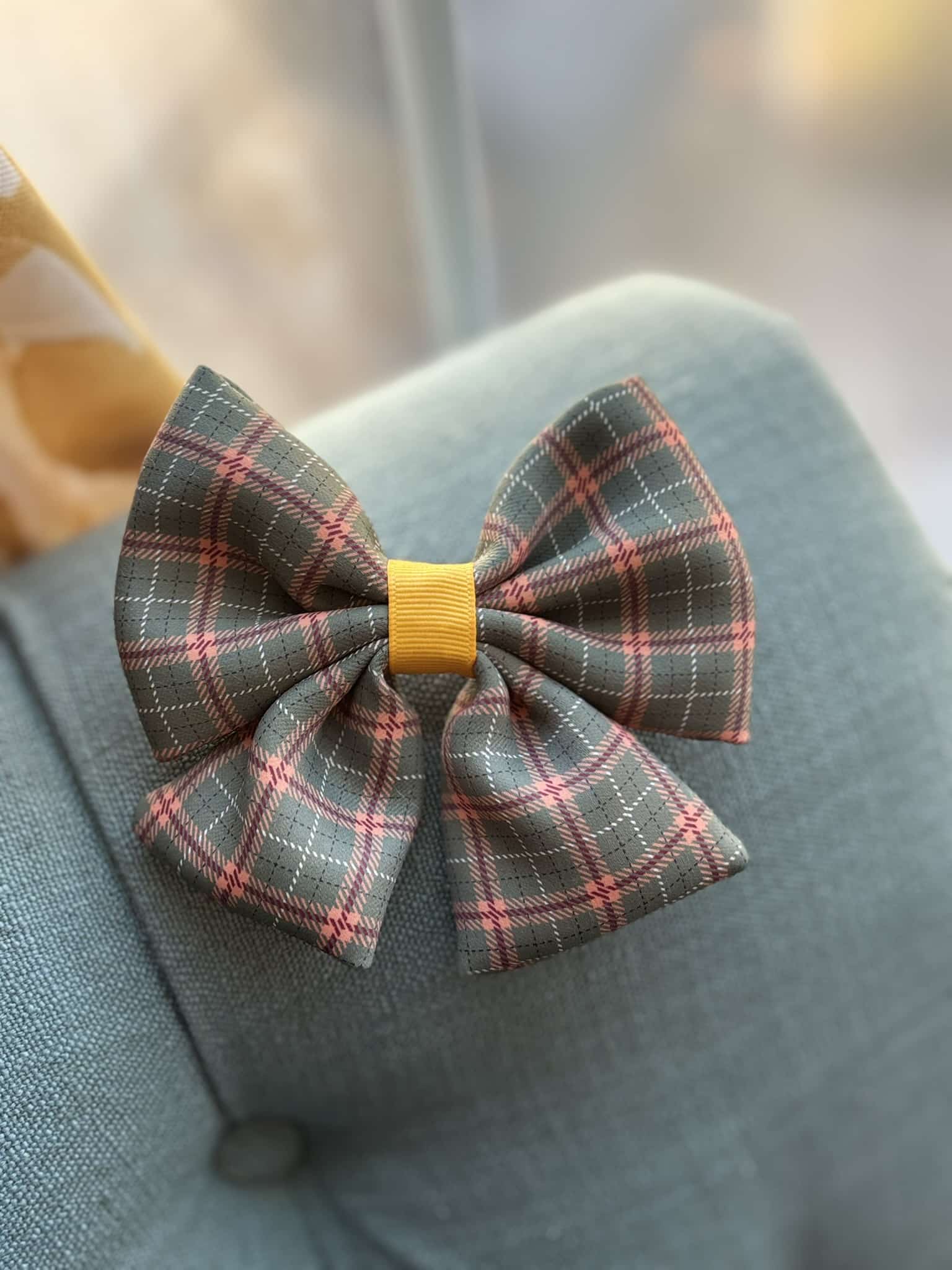 Plaid bow tie on fabric background.